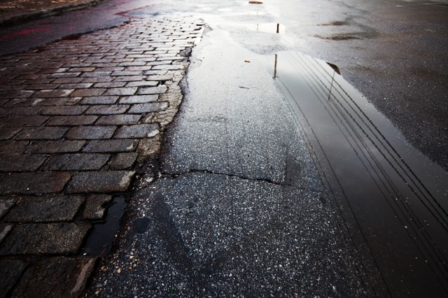 Belgian Block paving stones struggle against asphalt